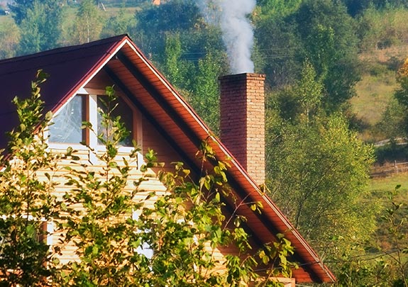 House in the mountains with a chimney and smoke coming out
