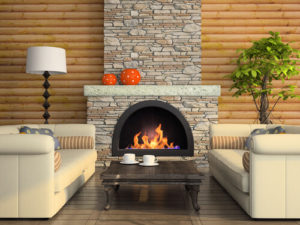 two couches with table in between in front of burning fireplace