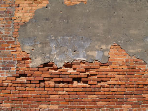 broken and crumbling brick wall