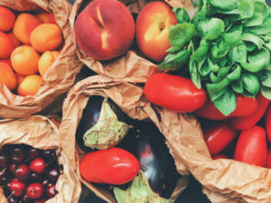 fruits and veggies in paper bags