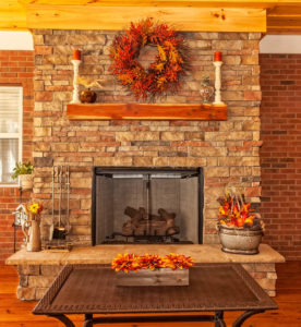 Fall decorations set up around mantle and fireplace